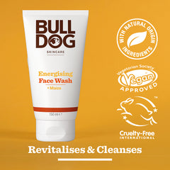 A tube of Energising Face Wash for men, shown on an orange background with maize. Labels highlight natural origin ingredients, vegan approval, cruelty-free certification, and text stating Revitalises & Cleanses.