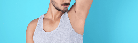Man smelling underarm