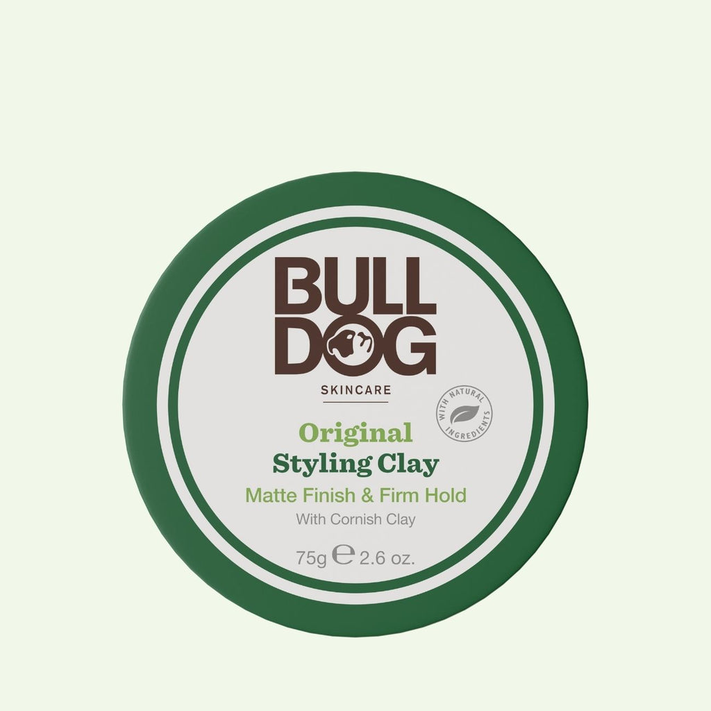 A round green and white container of Original Hair Styling Clay, labeled Matte Finish & Firm Hold, made with Kaolin and Cornish Clay, 75g (2.6 oz).