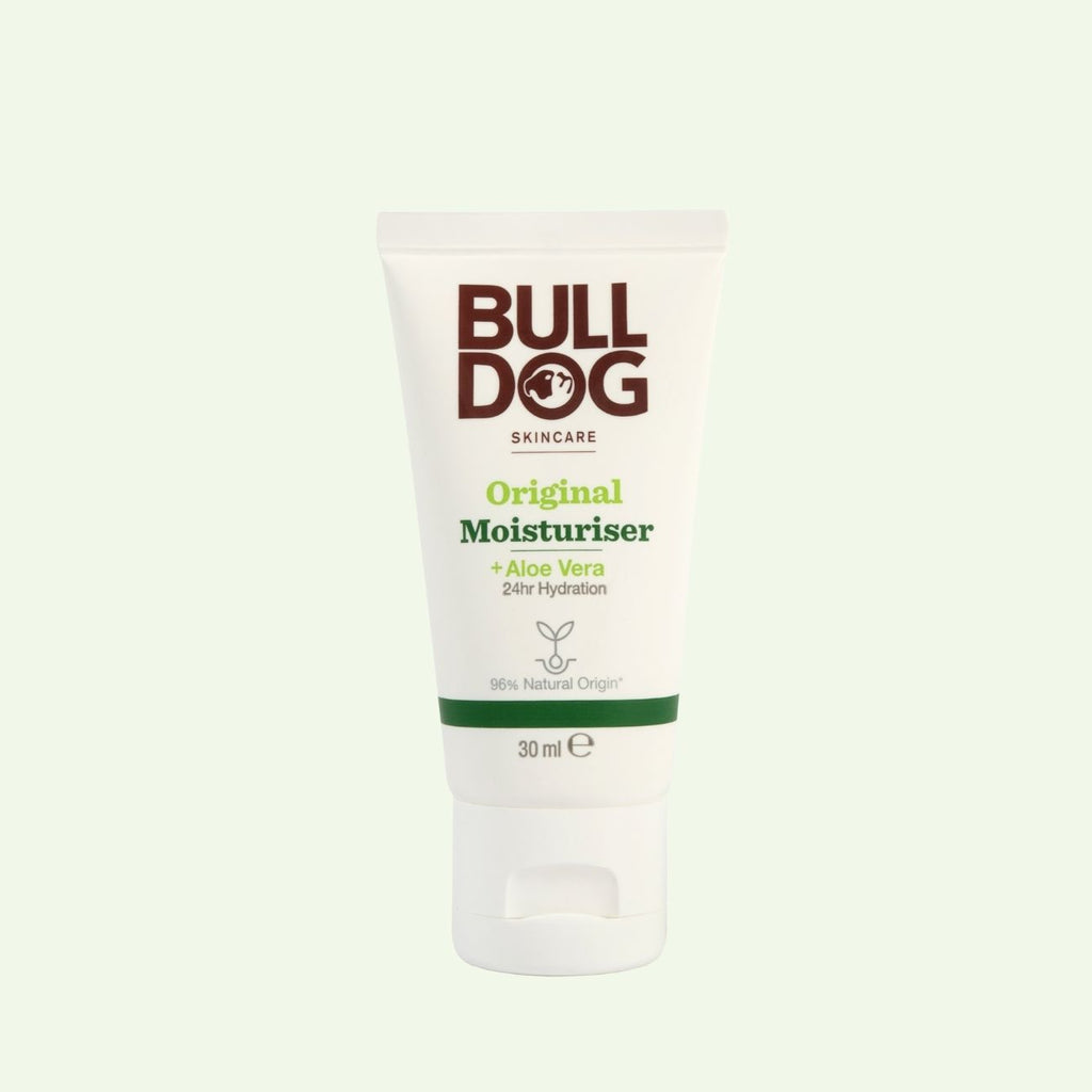 A white tube of Bulldog Skincare Travel Original Moisturiser for men, featuring 96% natural origin ingredients like aloe vera, offers 24-hour hydration in a 30ml size and stands upright on a pale background.