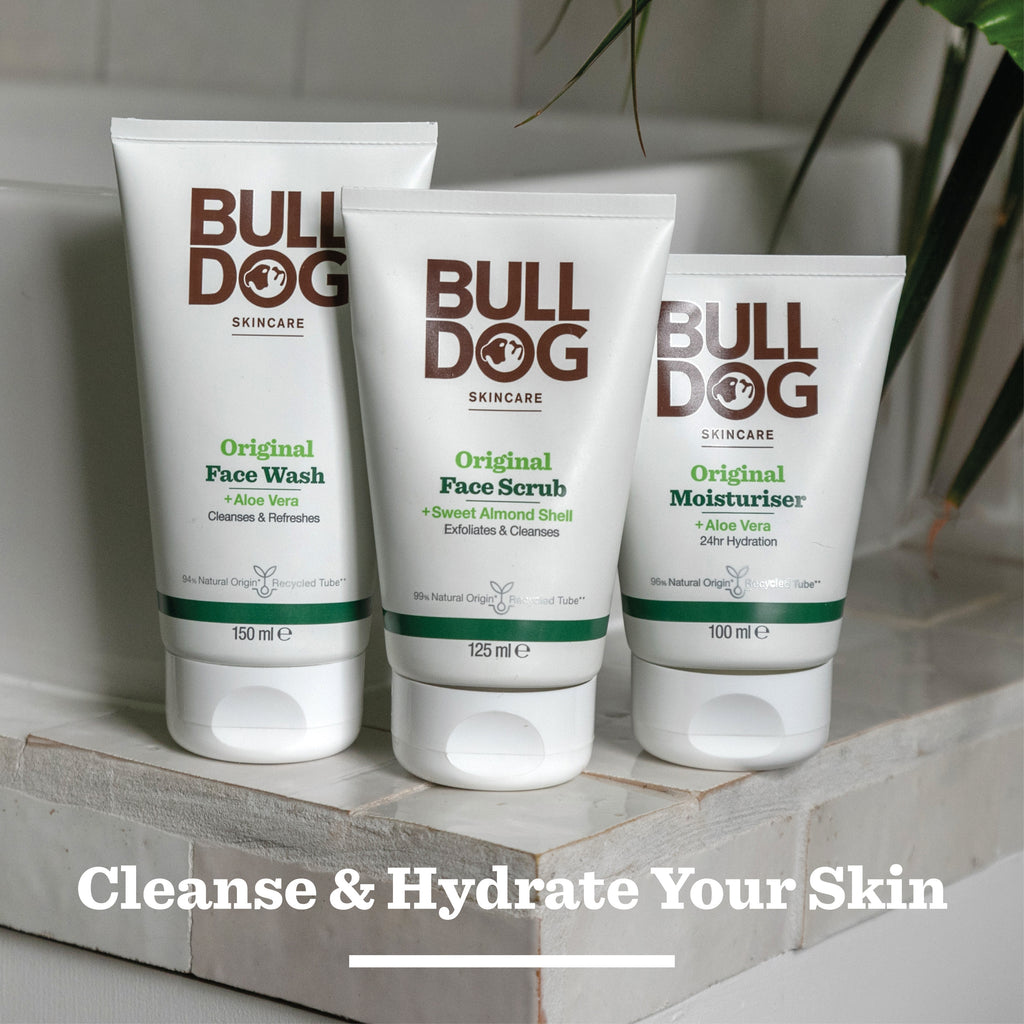 The Bulldog Skincare Original Mega Bundle is displayed on a bathroom sink with greenery in the background. Text below reads, “Cleanse & Hydrate Your Skin.”.