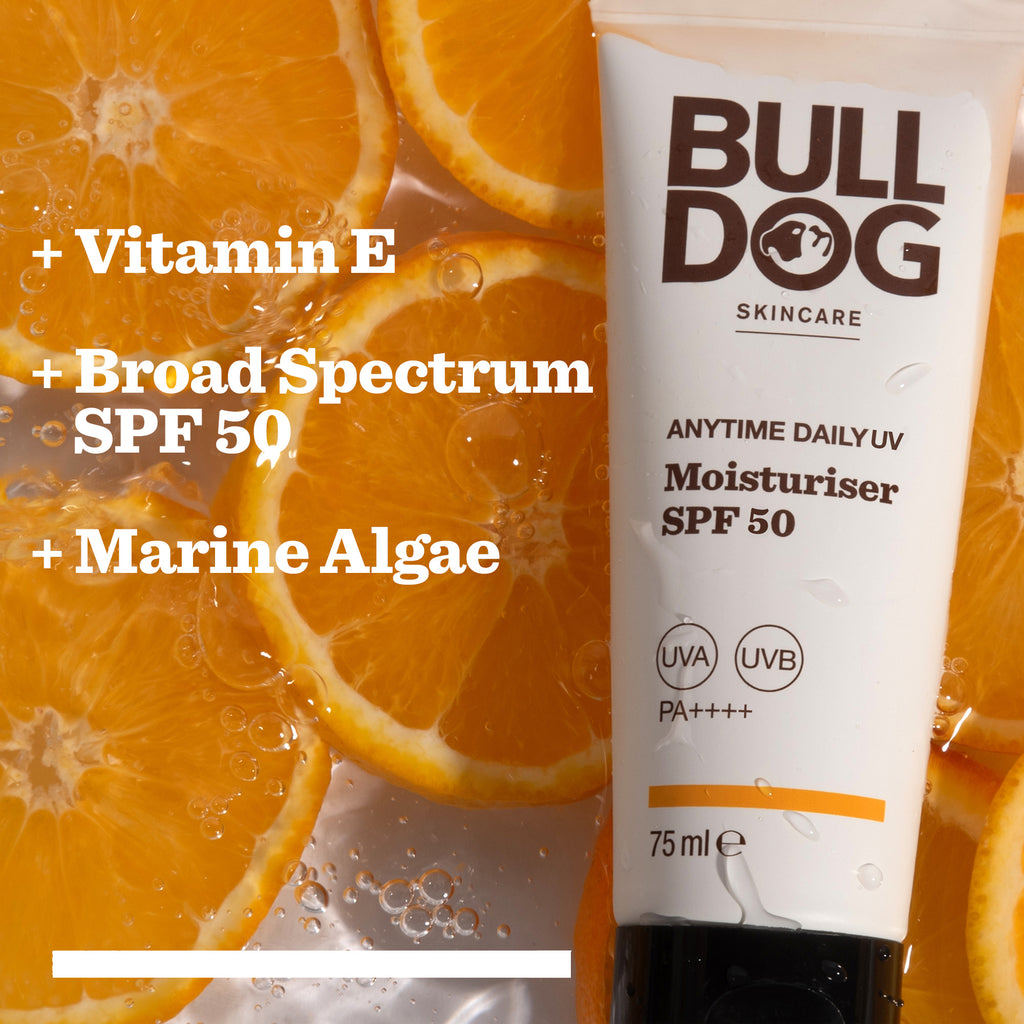 A tube of Anytime Daily UV Moisturiser SPF 50 rests on orange slices. Text highlights Vitamin E, Marine Algae, and Broad Spectrum SPF 50 for all-day hydration plus sweat-resistant sun protection.