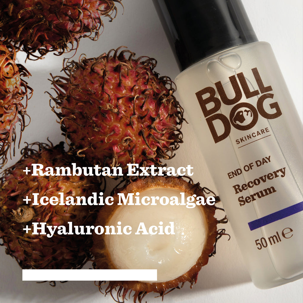 A bottle from the End of Day Collection Bundle lies beside rambutan fruits, one cut open to reveal its white interior. Text lists natural origin ingredients: rambutan extract, Icelandic microalgae, and hyaluronic acid.